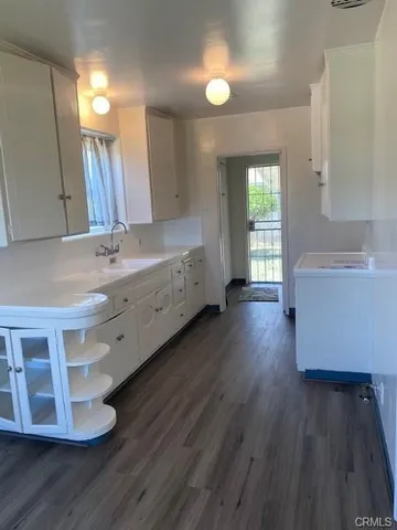 a spacious bathroom with a double vanity sink and a large mirror