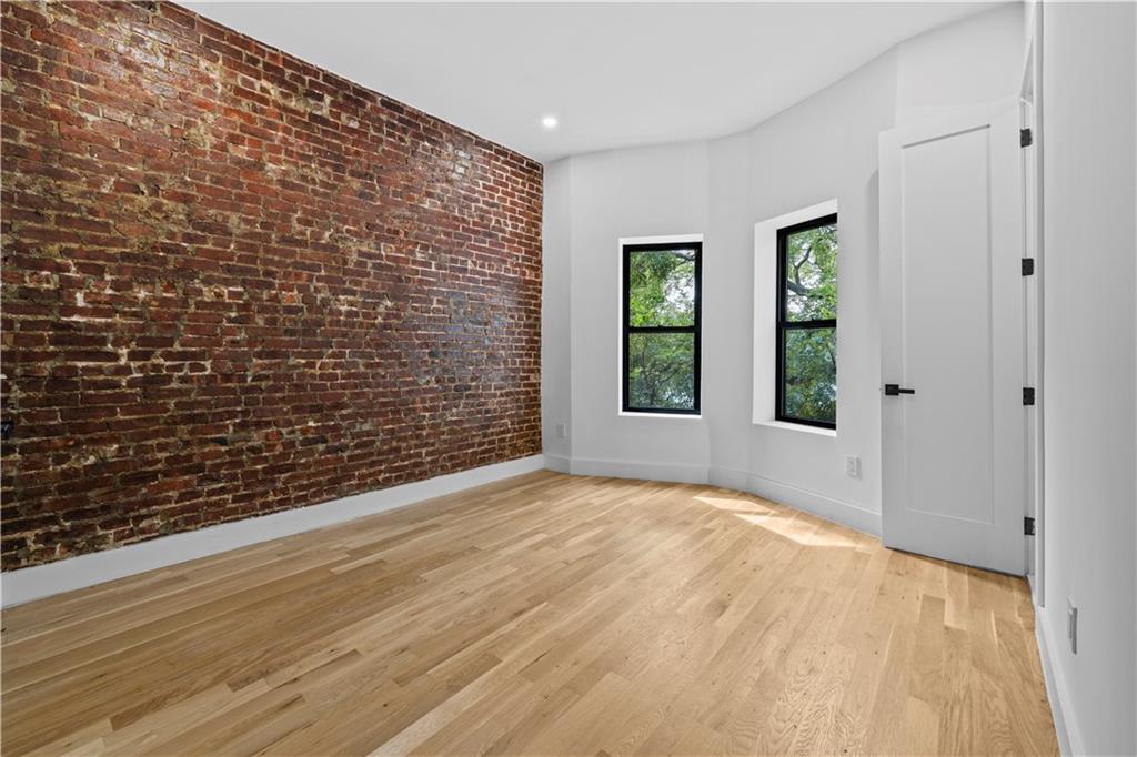 371 Grant Avenue Brooklyn, NY 11208 - Photo 11 of 19 a view of an empty room with a window