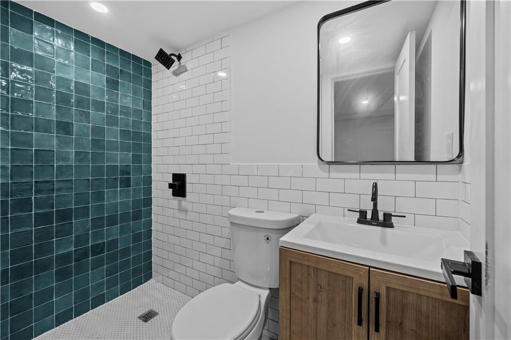 371 Grant Avenue Brooklyn, NY 11208 - Photo 18 of 19 a bathroom with a sink a toilet and mirror