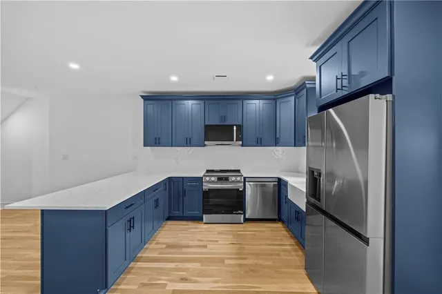 a kitchen with granite countertop stainless steel appliances and wooden cabinets