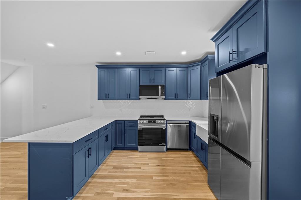 371 Grant Avenue Brooklyn, NY 11208 - Photo 7 of 19 a kitchen with granite countertop stainless steel appliances and wooden cabinets