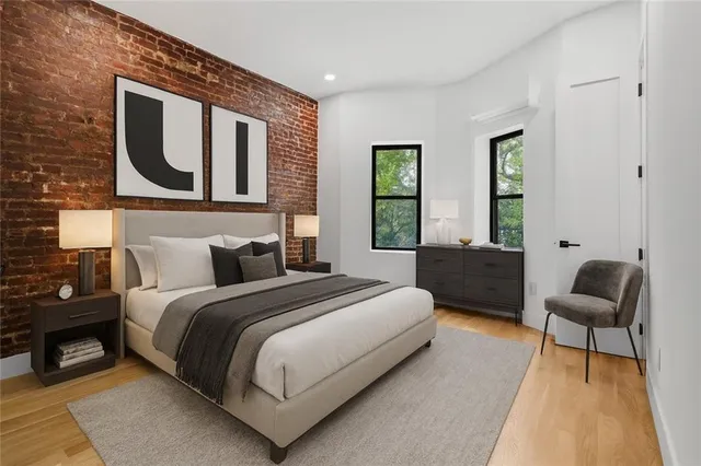 a spacious bedroom with a bed and window