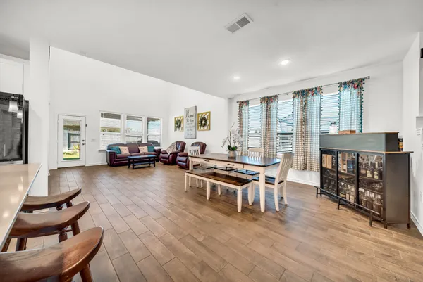a living room with furniture a flat screen tv and a large window