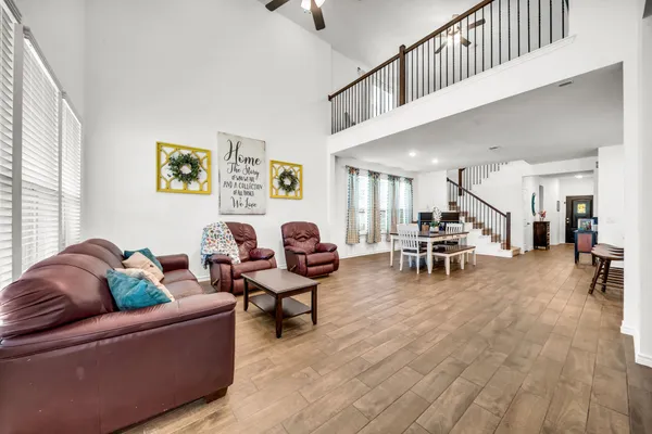 a living room with furniture and a wooden floor