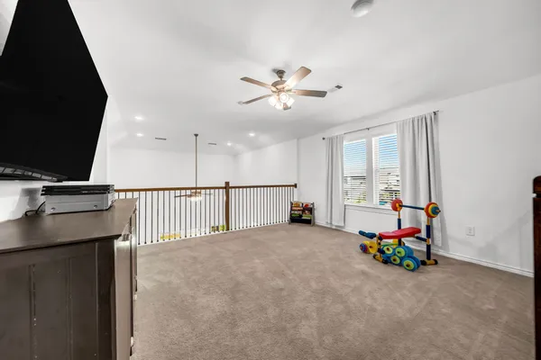 a view of a livingroom with furniture and a flat screen tv
