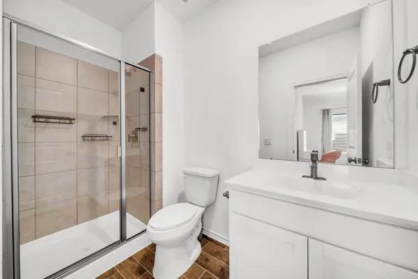 a bathroom with a sink toilet and shower