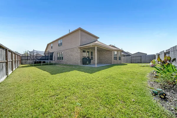 a view of house with backyard