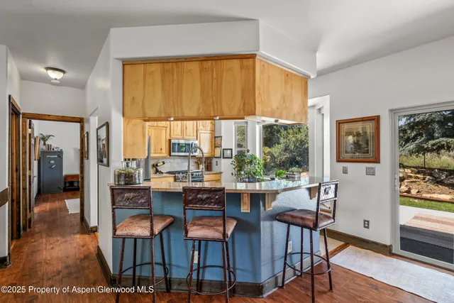 a kitchen with stainless steel appliances granite countertop a sink and cabinets