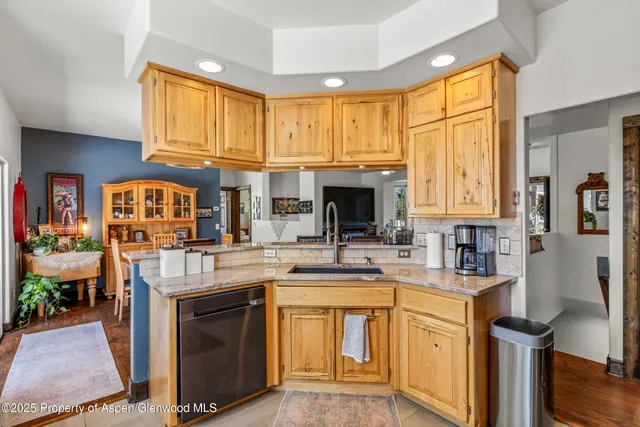 a kitchen with stainless steel appliances granite countertop a stove refrigerator sink and microwave
