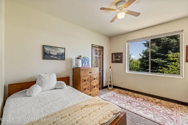 a bedroom with a bed furniture and a chandelier