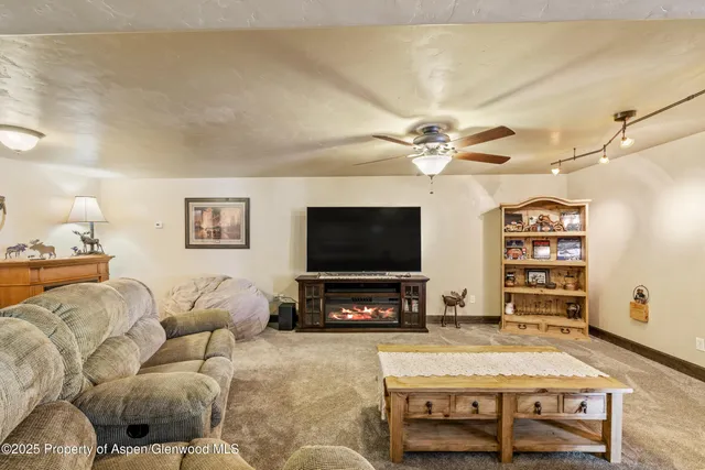 a living room with furniture gym equipment and a window
