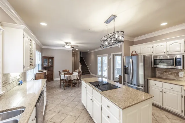 a large kitchen with a table and chairs