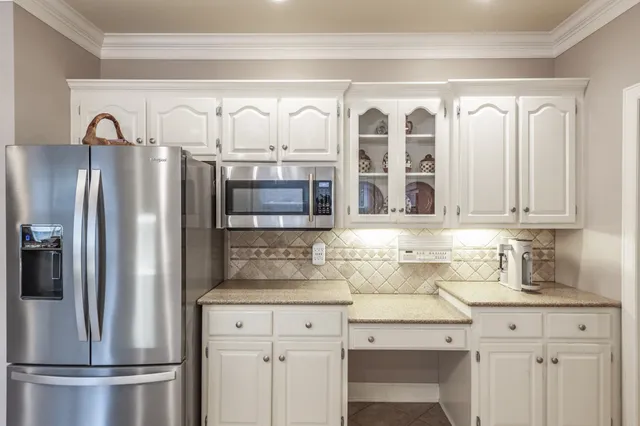 a bedroom with a bed painting on wall and a window