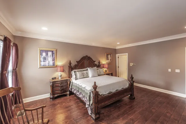 a white toilet sitting next to a white wall and a sink