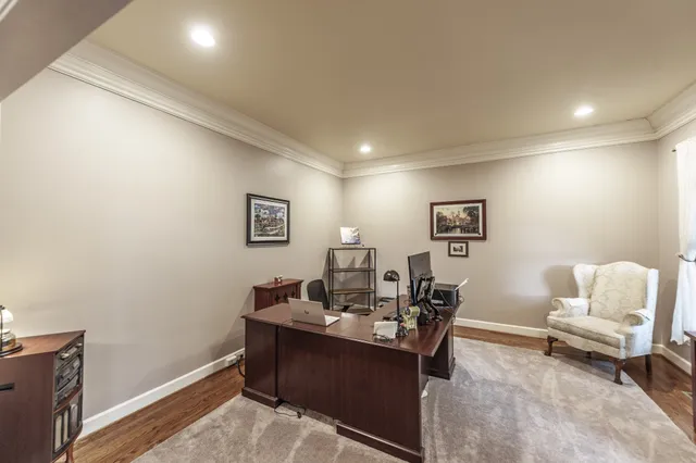 a view of a livingroom with a dinning area wooden floor and a window