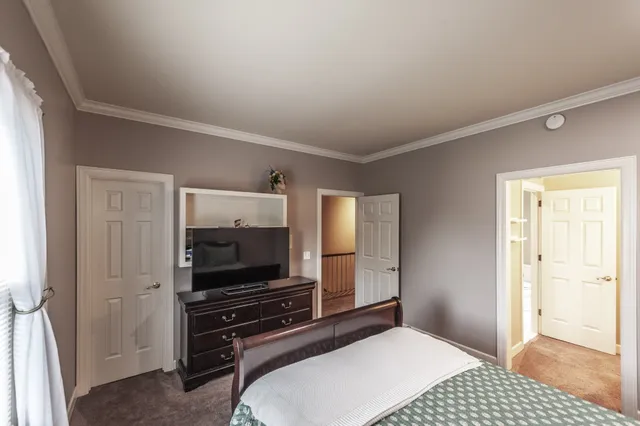 a view of a patio with table and chairs and wooden fence