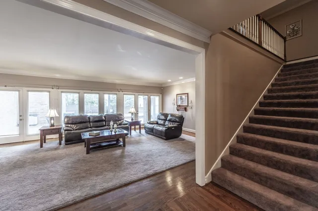 a dining room with furniture a chandelier and window