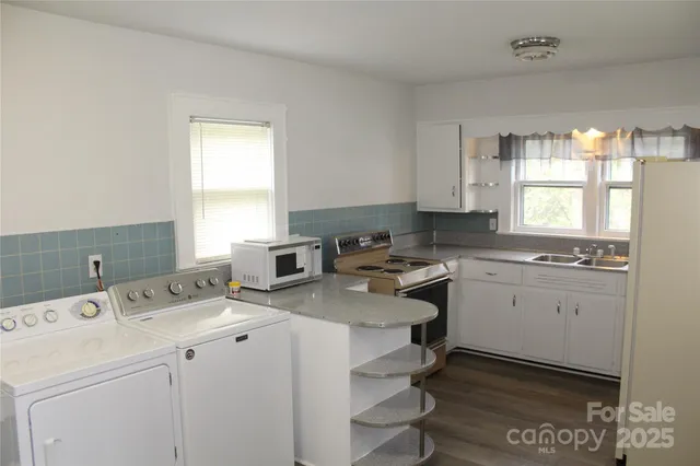 a room with a sink cabinets and window