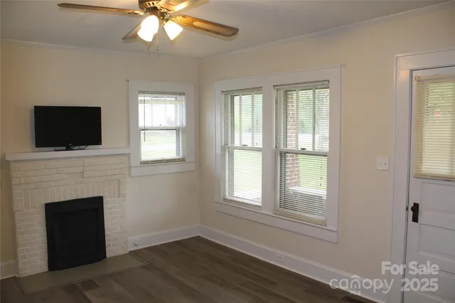a living room with a fireplace and a flat screen tv