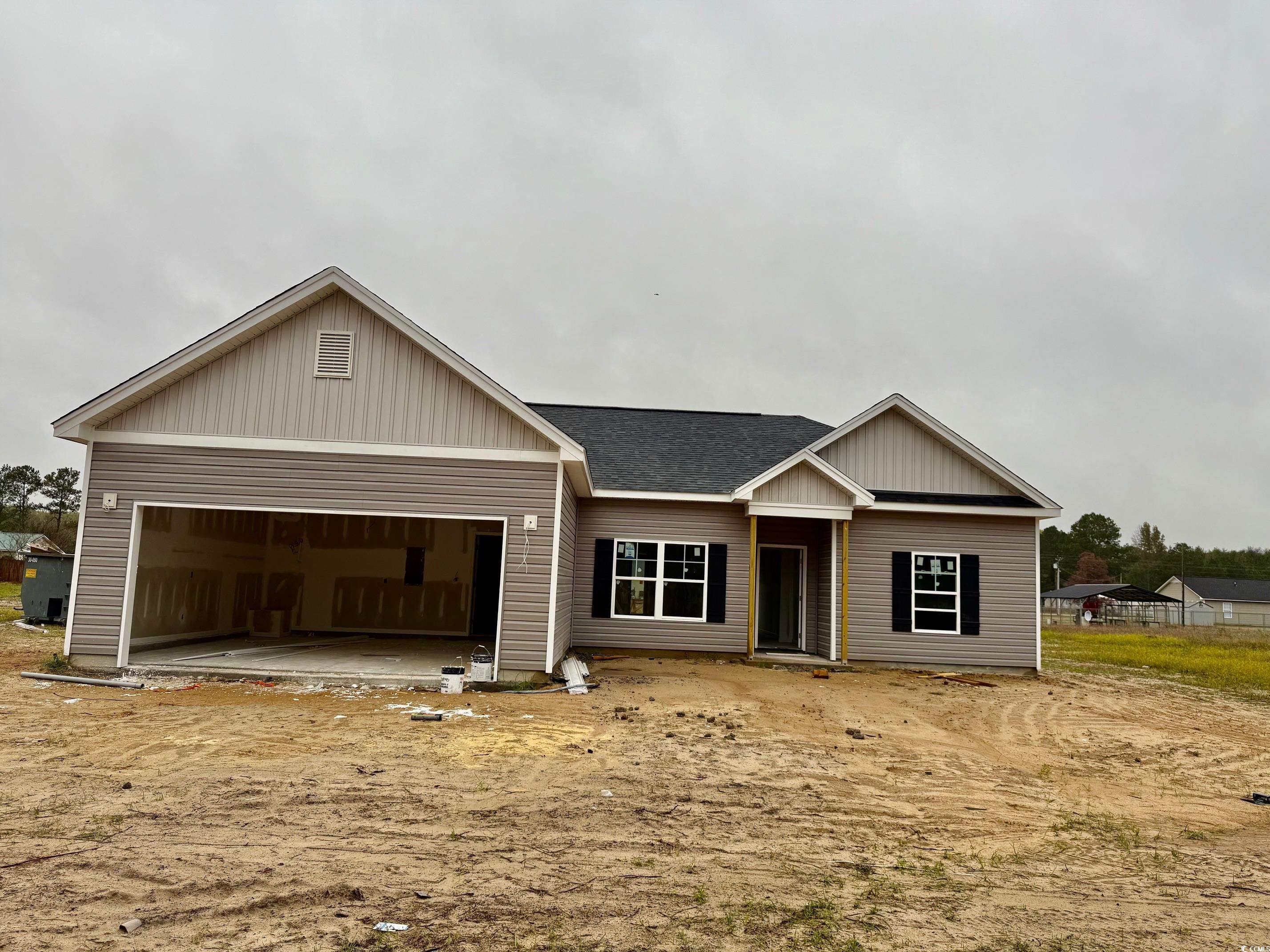 282 Lexyryan Court Latta, SC 29565 - Photo 1 of 8 View of front of home with roof with shingles and an attached garage