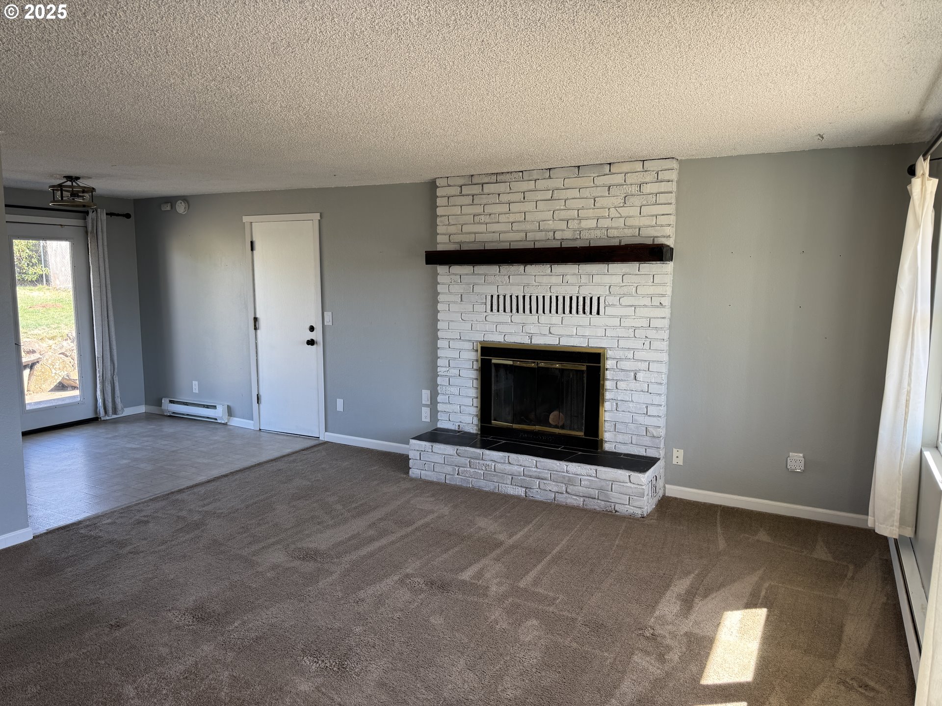 328 Allison Way Goldendale, WA 98620 - Photo 2 of 31 an empty room with a fireplace