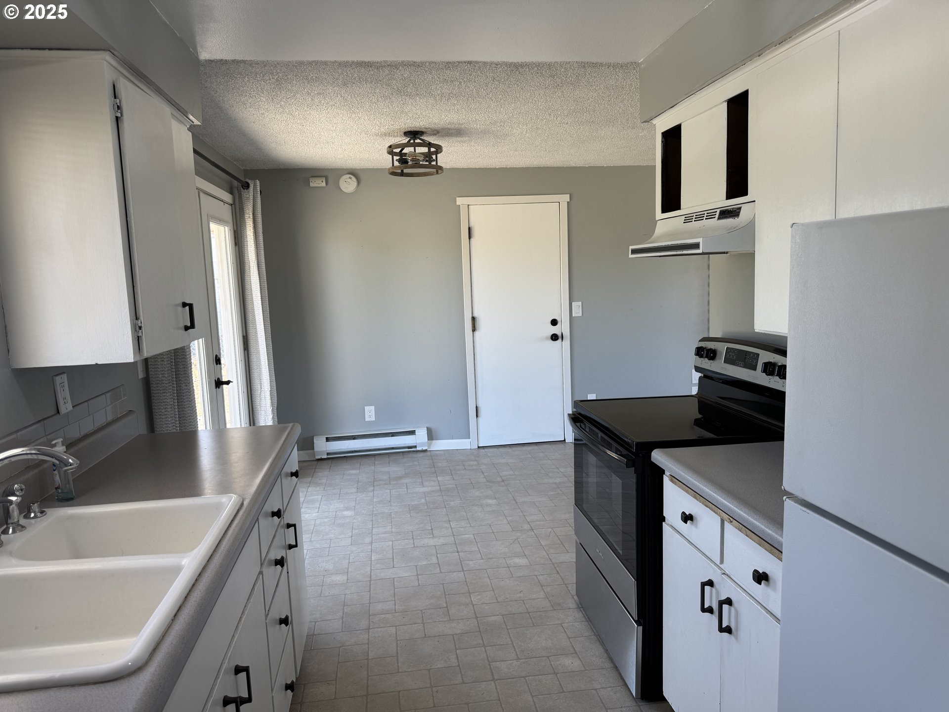 328 Allison Way Goldendale, WA 98620 - Photo 10 of 31 a kitchen with a sink stove and refrigerator
