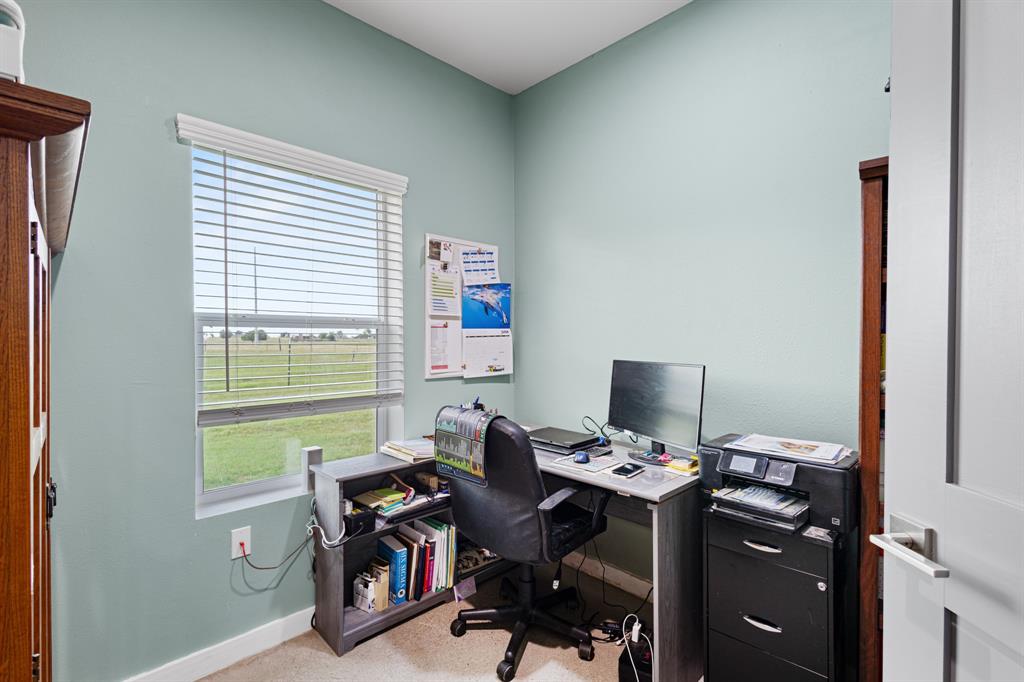 124 County Road 4511 Decatur, TX 76234 - Photo 12 of 39 a view of a workspace with furniture and a window