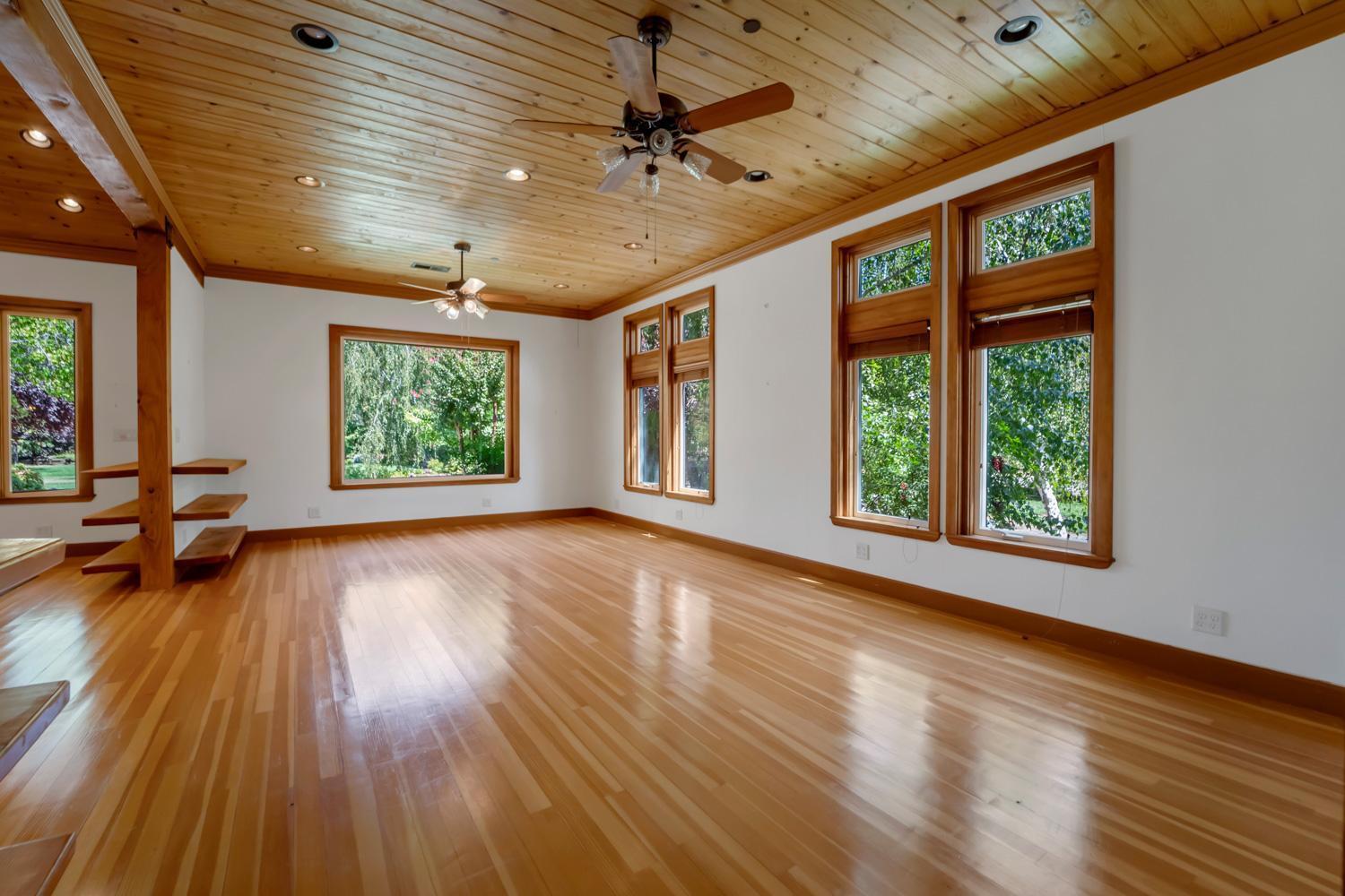 683 Stewart Road Yuba City, CA 95991 - Photo 12 of 55 a view of an empty room with wooden floor and a window