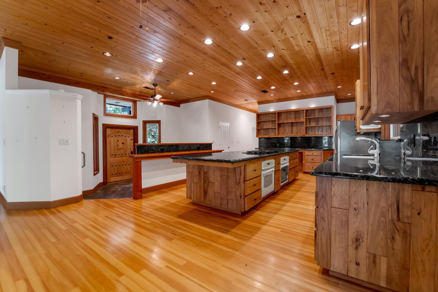 683 Stewart Road Yuba City, CA 95991 - Photo 18 of 55 a kitchen with stainless steel appliances granite countertop a stove and a wooden floors