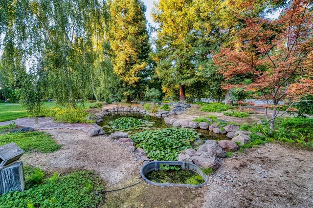 a backyard of a house with a garden and outdoor seating