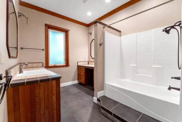 a bathroom with a sink a mirror and a bathtub