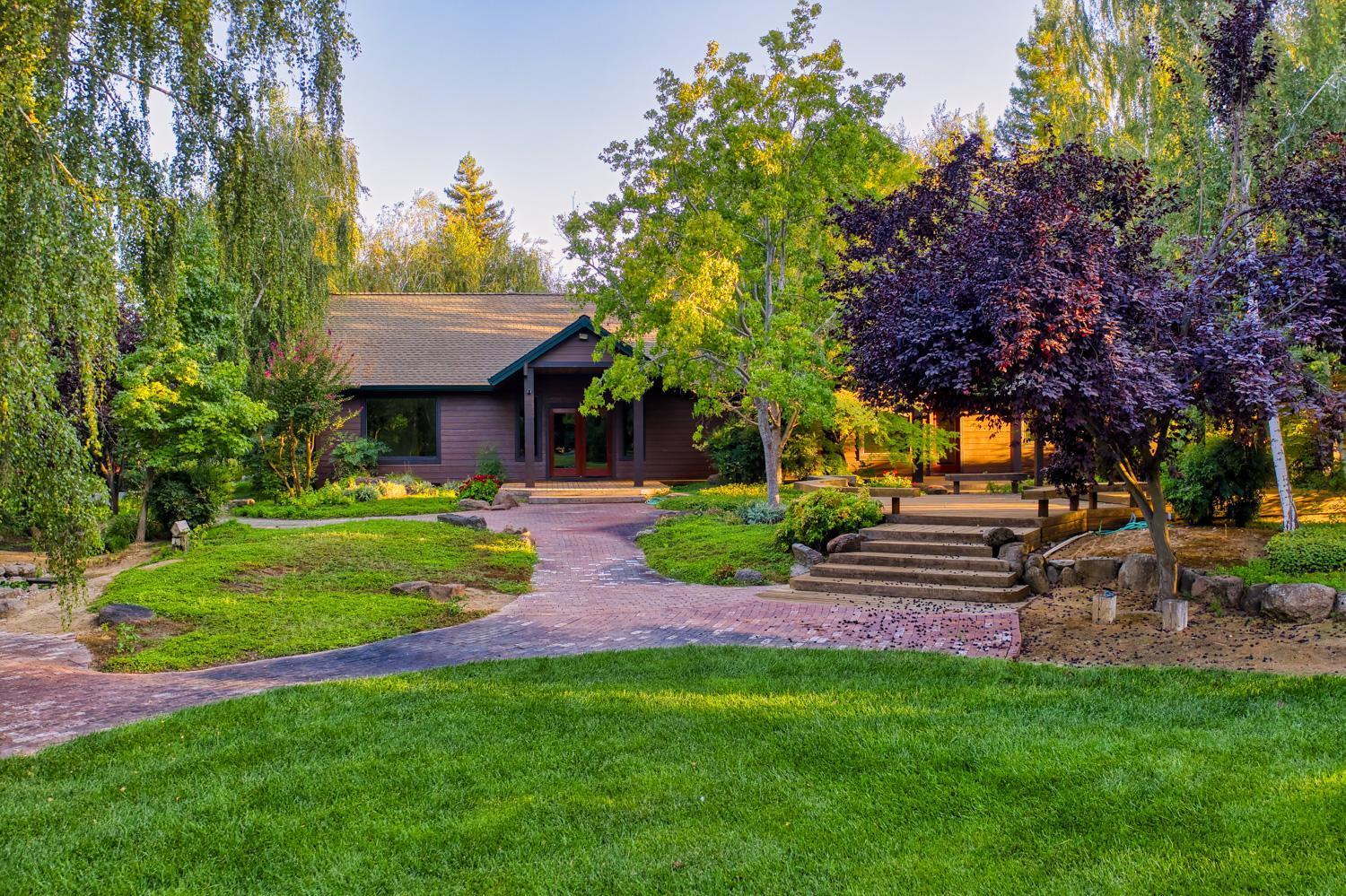 683 Stewart Road Yuba City, CA 95991 - Photo 52 of 55 a view of a backyard with table and chairs plants and trees
