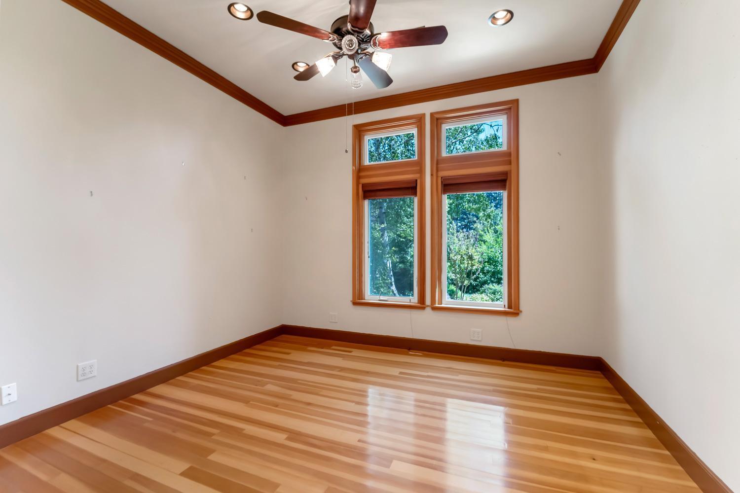 683 Stewart Road Yuba City, CA 95991 - Photo 9 of 55 a view of an empty room with wooden floor and a window
