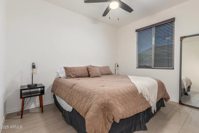 a bedroom with a bed and a night stand