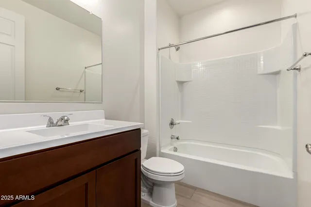 a living room with furniture and a ceiling fan