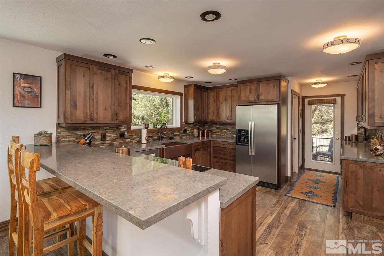 21530 Sazarac Road Reno, NV 89521 - Photo 13 of 30 a kitchen with stainless steel appliances granite countertop a sink a stove and a refrigerator
