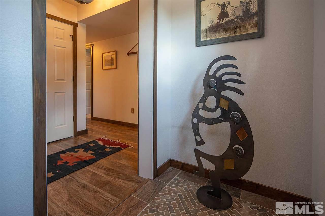 21530 Sazarac Road Reno, NV 89521 - Photo 21 of 30 a view of a hallway with paintings on the wall