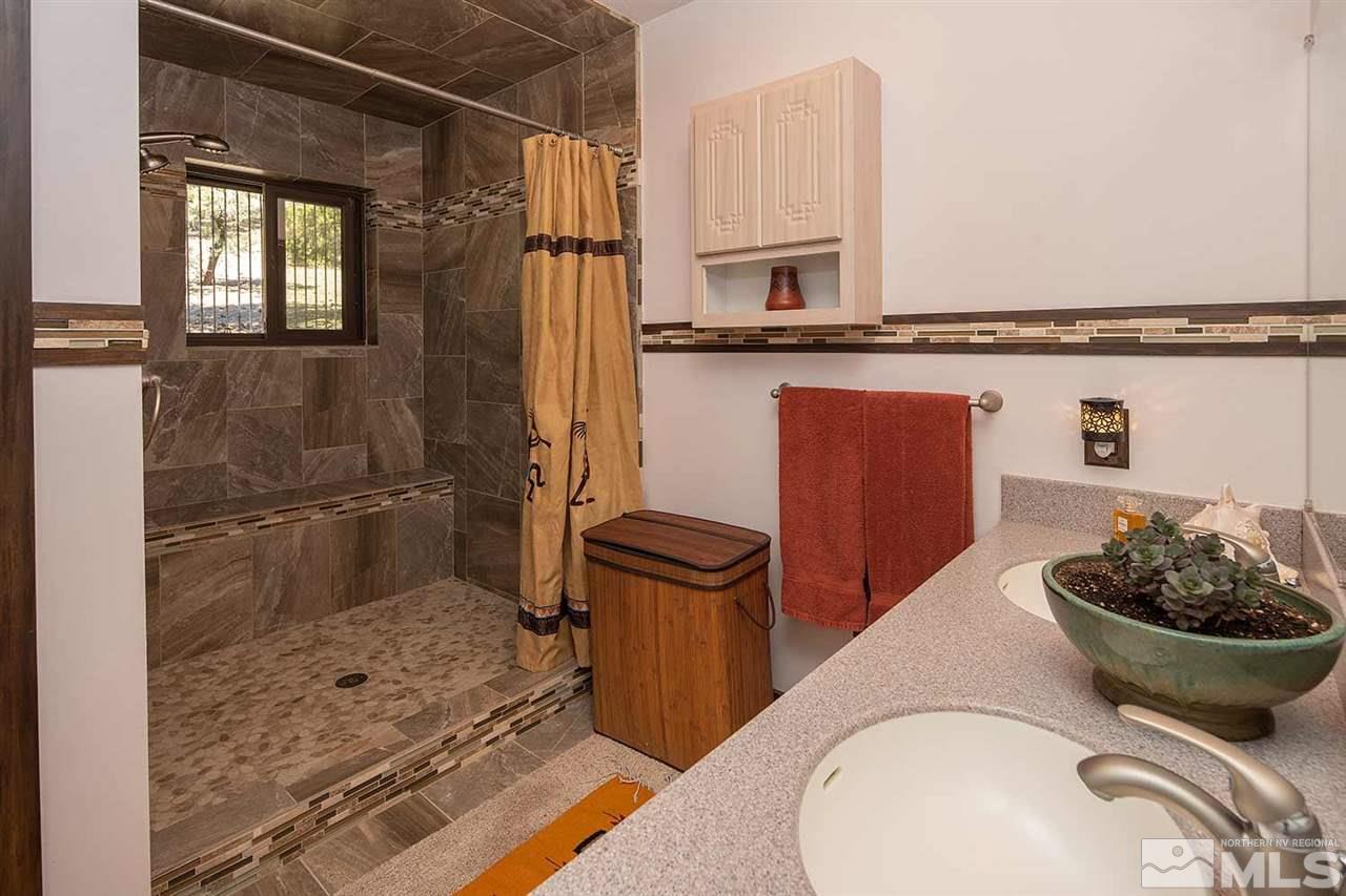 21530 Sazarac Road Reno, NV 89521 - Photo 23 of 30 a bathroom with a sink a toilet and a mirror