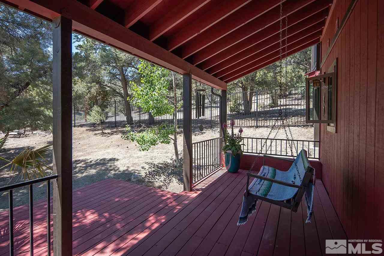 21530 Sazarac Road Reno, NV 89521 - Photo 24 of 30 a view of a porch with furniture and wooden floor