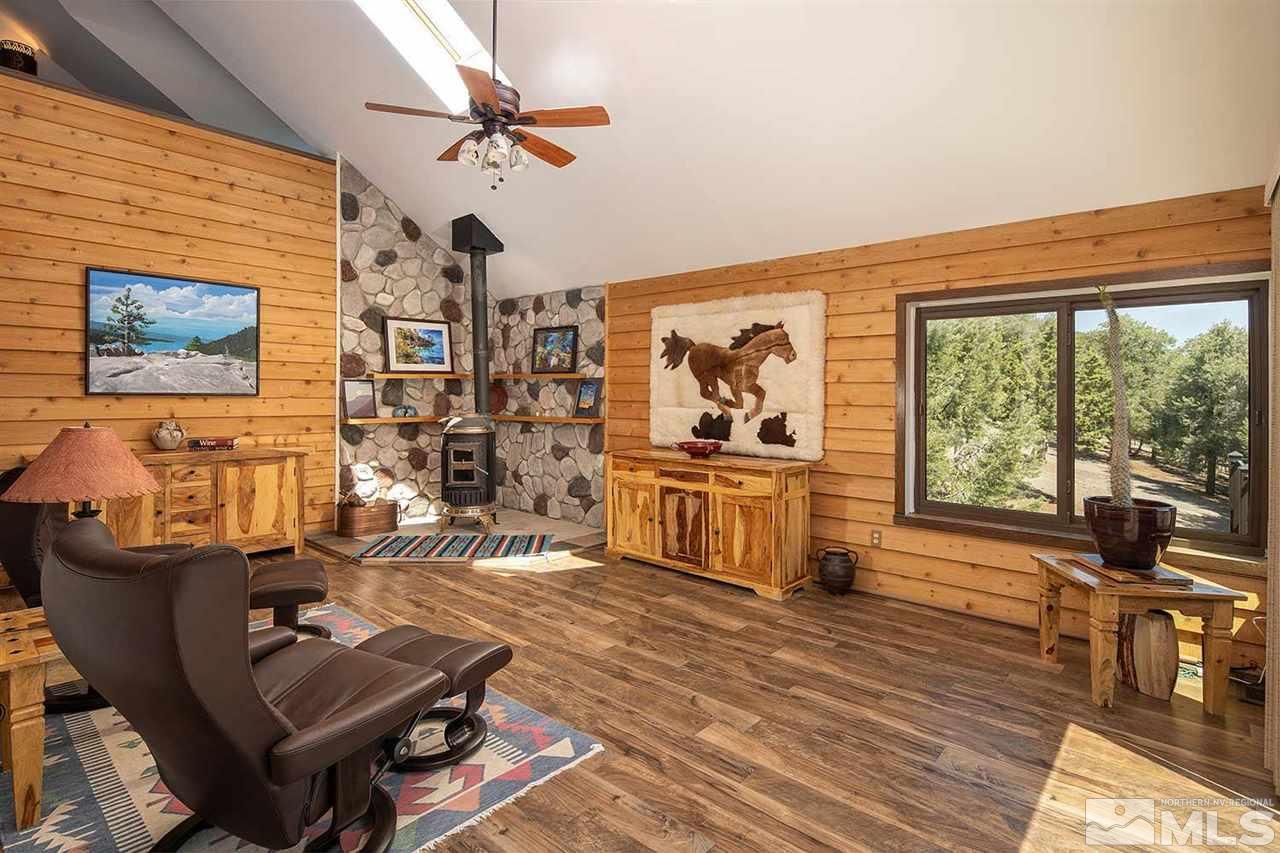 21530 Sazarac Road Reno, NV 89521 - Photo 9 of 30 a living room with furniture a rug potted plant and a large window