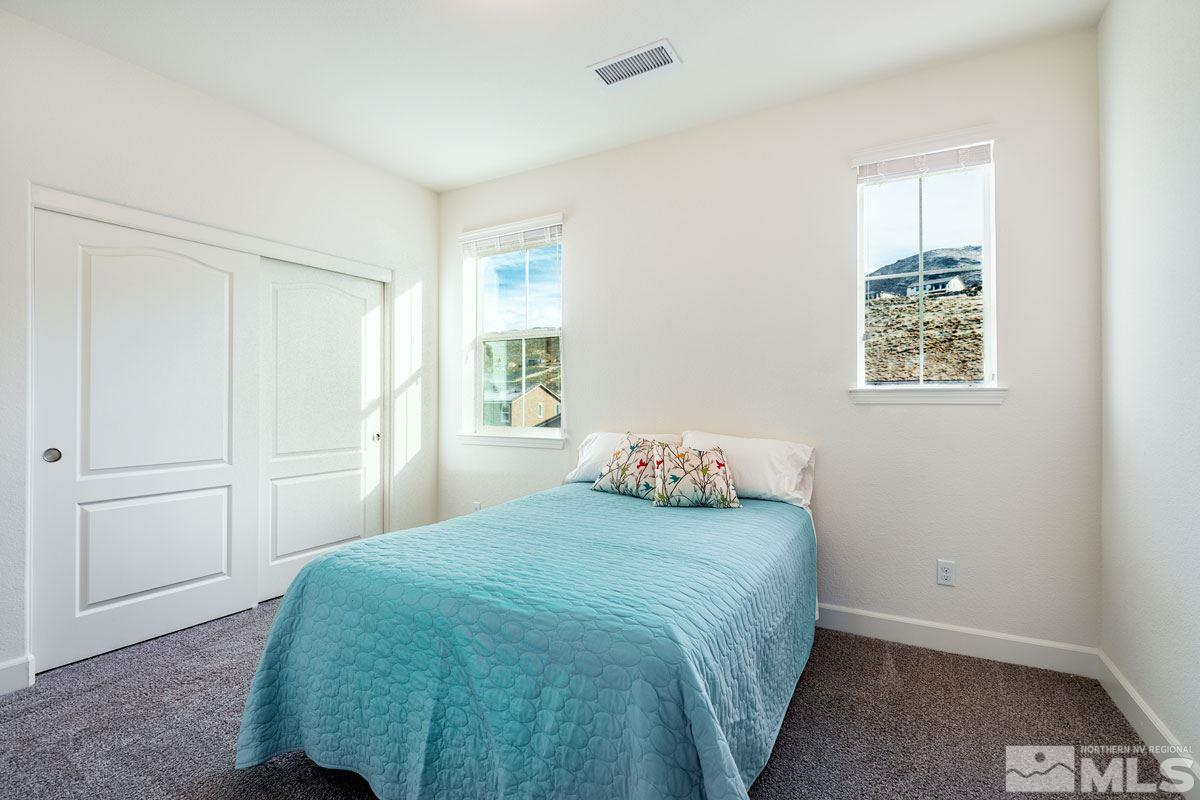 10335 Gold Mine Drive Reno, NV 89521 - Photo 13 of 24 a bedroom with a bed and a window