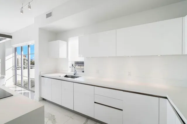 a kitchen with a sink and cabinets