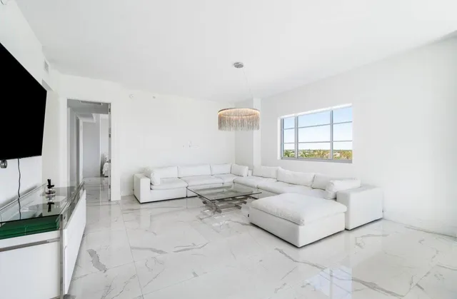 a bedroom with two beds and a large window