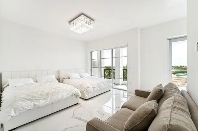 a spacious bedroom with a bed and a large window