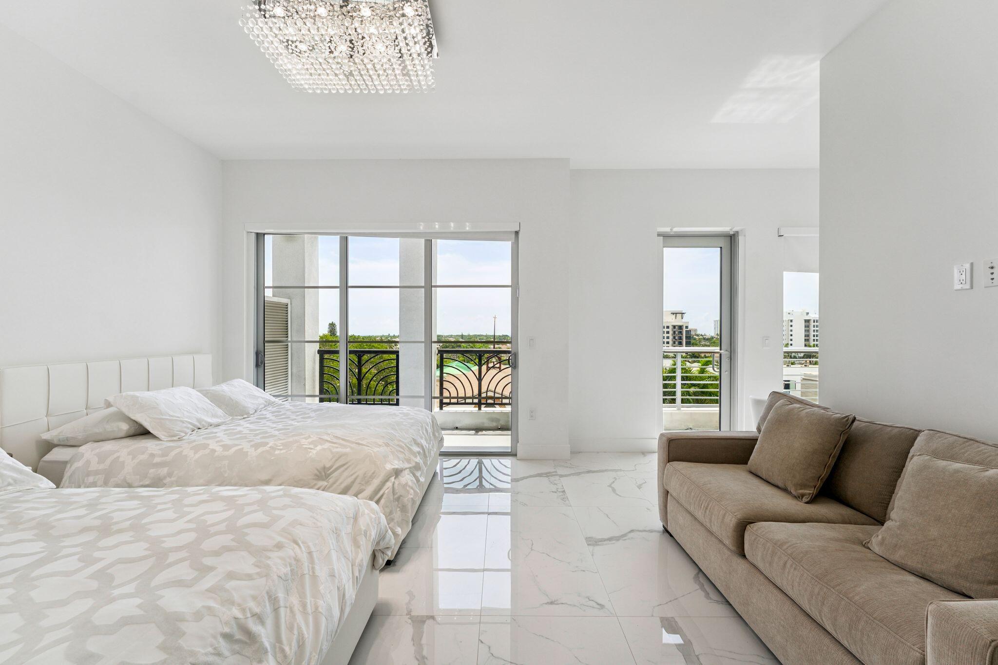 155 East Boca Raton Road, Unit 603 Boca Raton, FL 33432 - Photo 18 of 55 a spacious bedroom with a bed and a large window