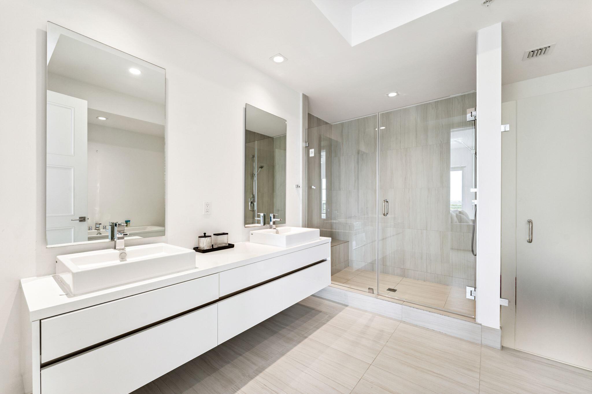 155 East Boca Raton Road, Unit 603 Boca Raton, FL 33432 - Photo 23 of 55 a bathroom with a double vanity sink mirror and shower