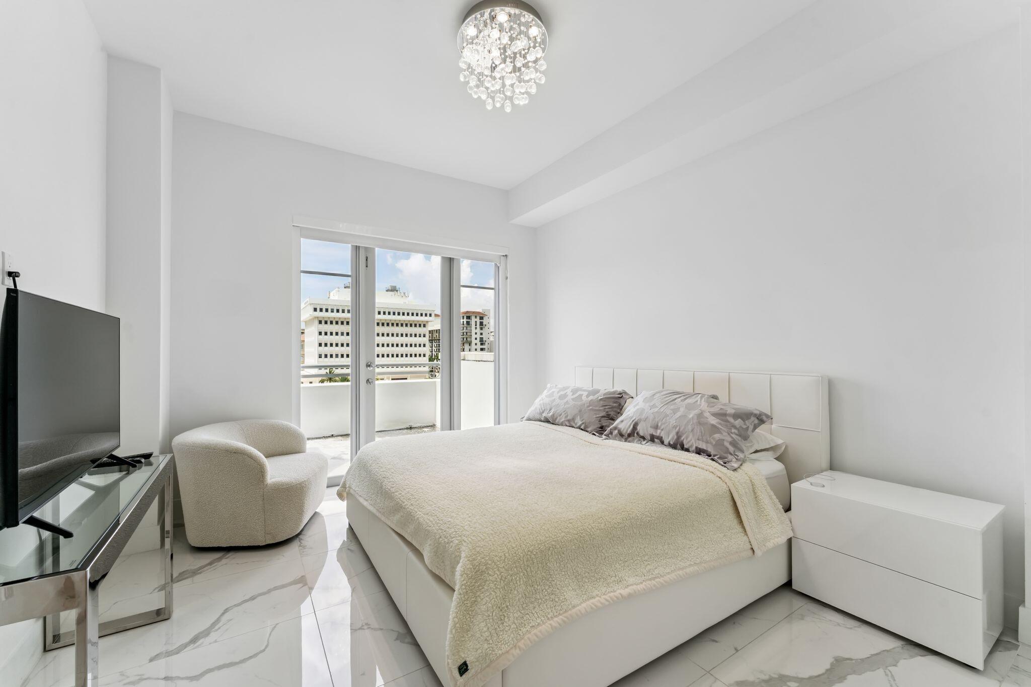 155 East Boca Raton Road, Unit 603 Boca Raton, FL 33432 - Photo 27 of 55 a bedroom with a bed and a flat screen tv