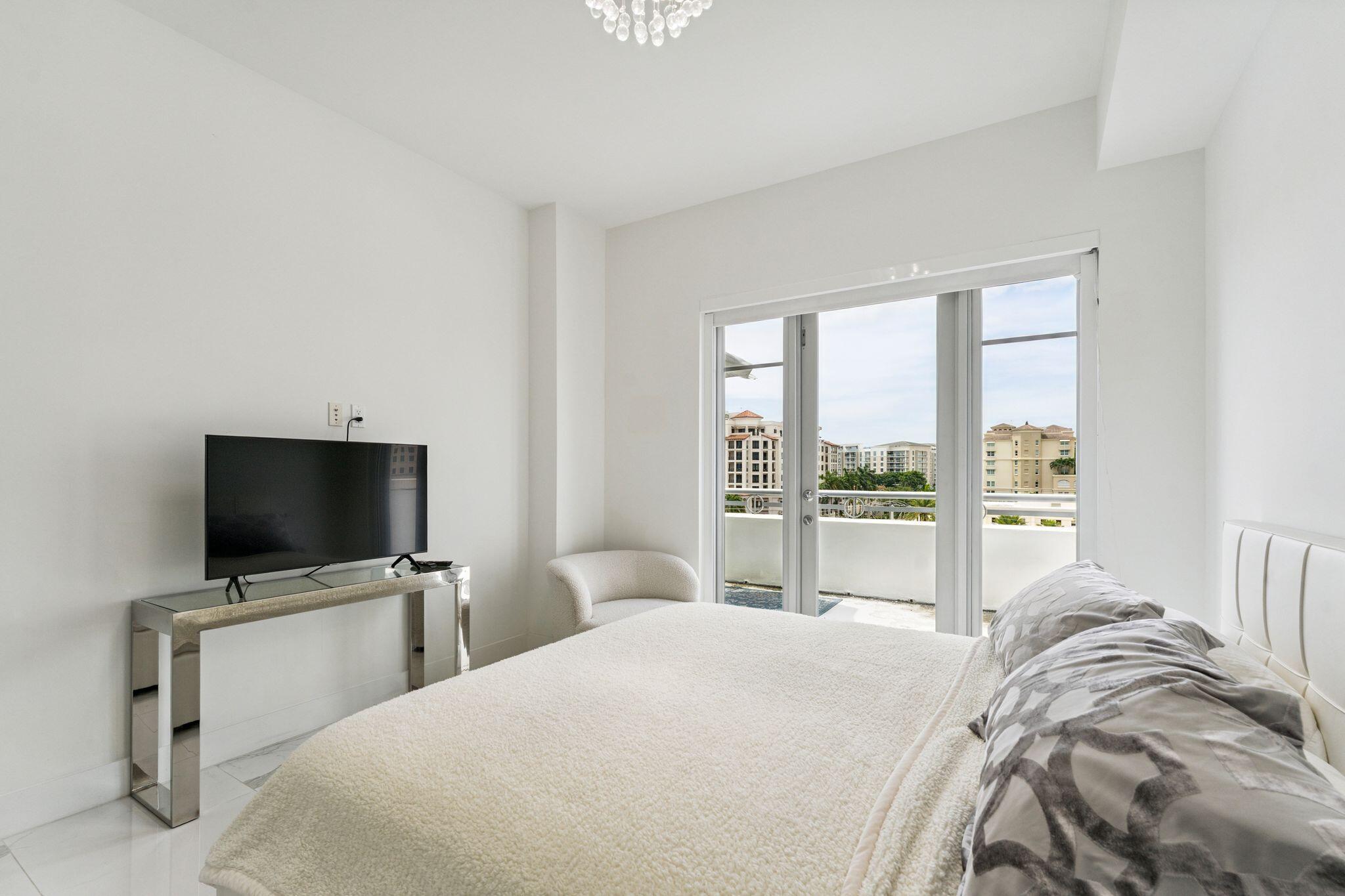 155 East Boca Raton Road, Unit 603 Boca Raton, FL 33432 - Photo 28 of 55 a bedroom with a bed and a flat screen tv