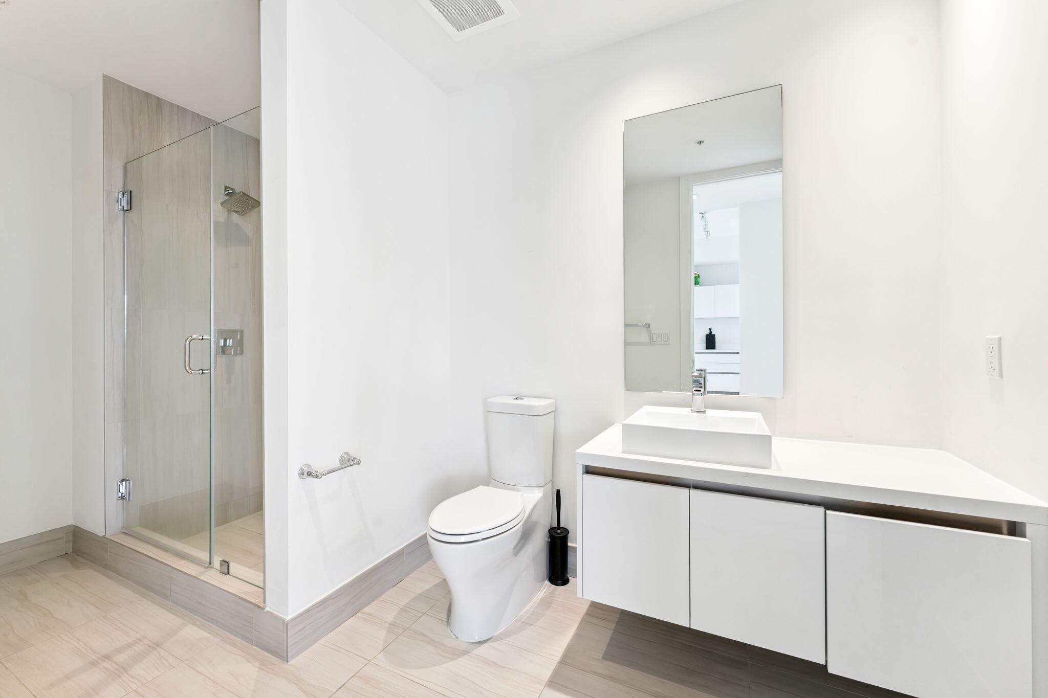 155 East Boca Raton Road, Unit 603 Boca Raton, FL 33432 - Photo 29 of 55 a bathroom with a sink a toilet and shower