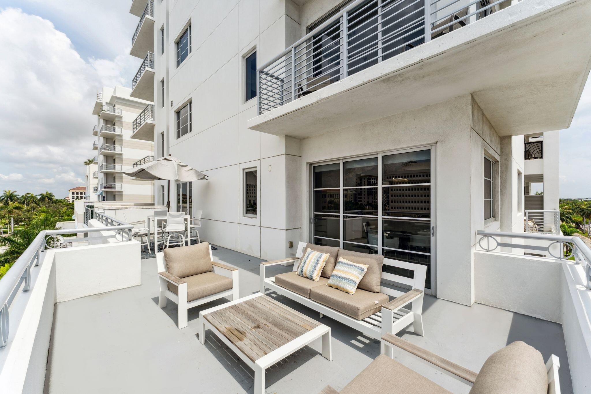 155 East Boca Raton Road, Unit 603 Boca Raton, FL 33432 - Photo 3 of 55 a view of a patio with couches and a table and chairs